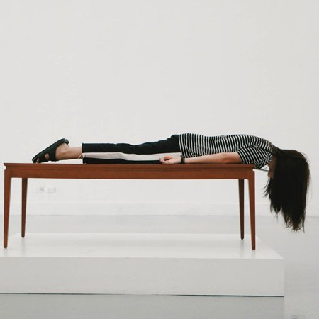 woman lying on table top, hair hanging down. Ageing and sleeping. Insomnia the challenging health issue for older people.