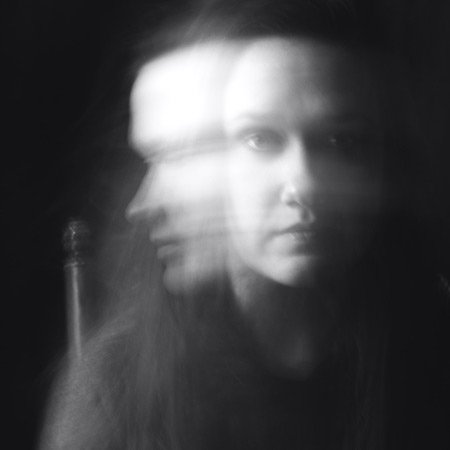 black and white photo of blurred woman showing movement