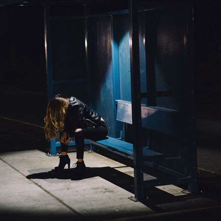 desperate woman at bus stop, night photo,