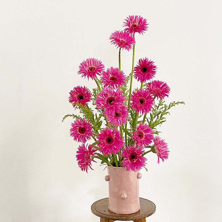 Pink flowers, space in between, pink vase, flower design
