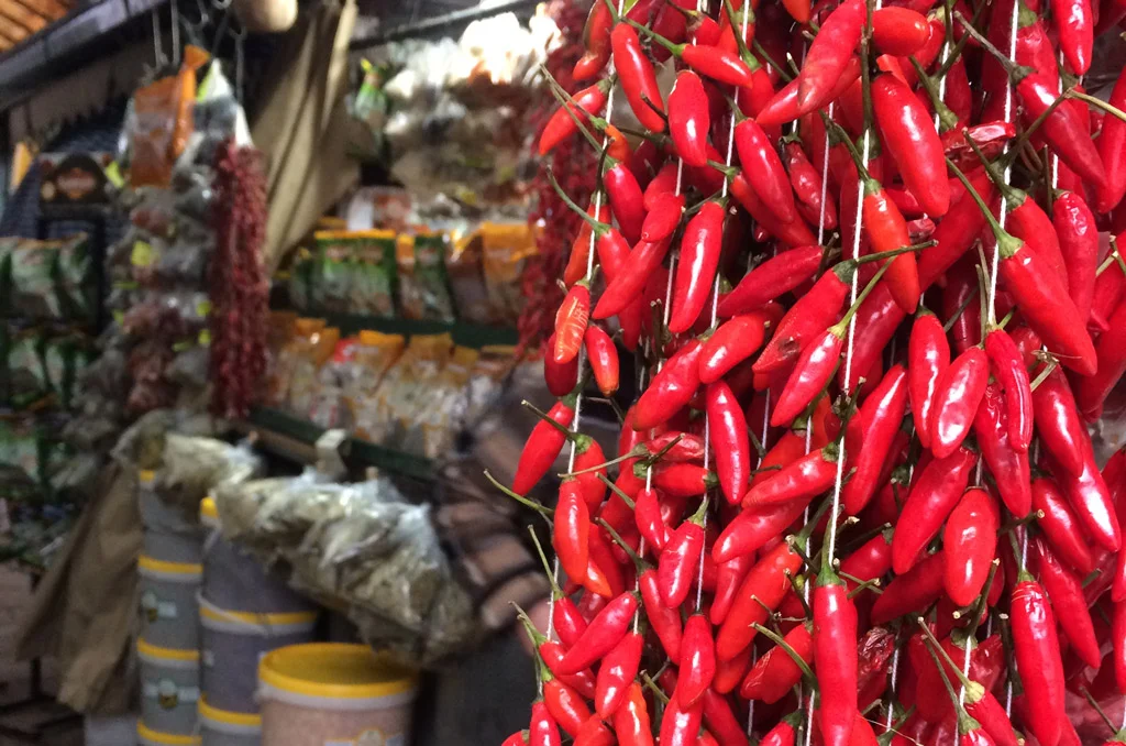 red peppers on the foreground and other gray packages in the background color photography at a food market