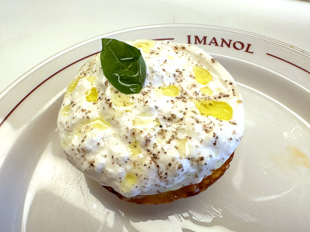 Spanish tapas: Burrata and tomato jam with a leaf on tops