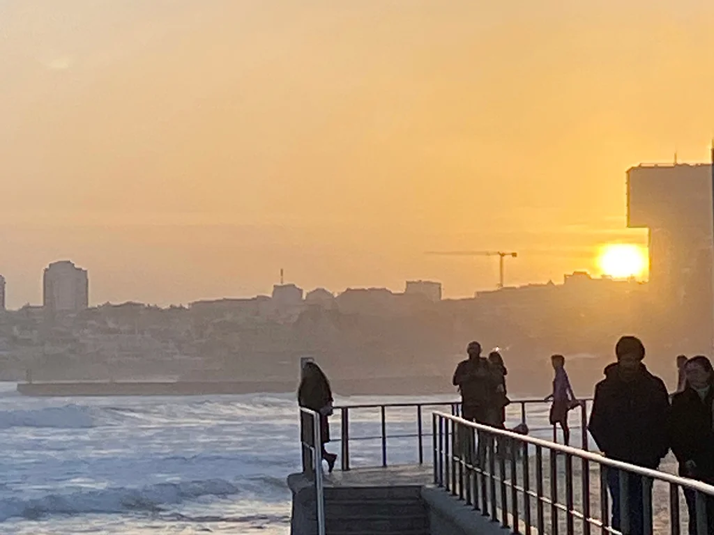 sunset, people on a bridge